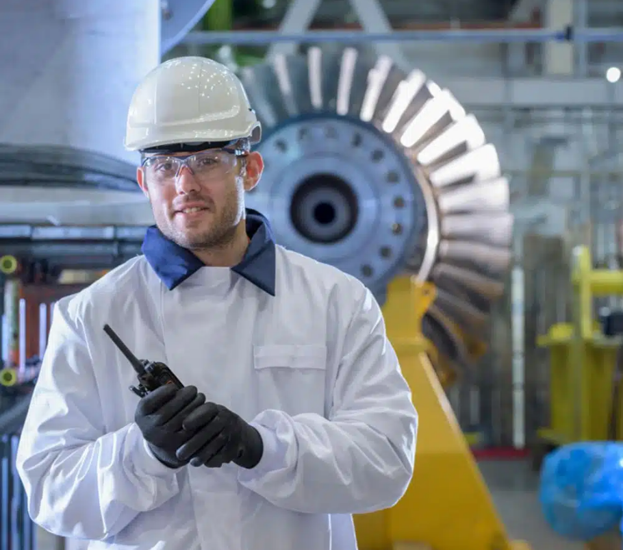 Manufacturing worker using a two-way radio.